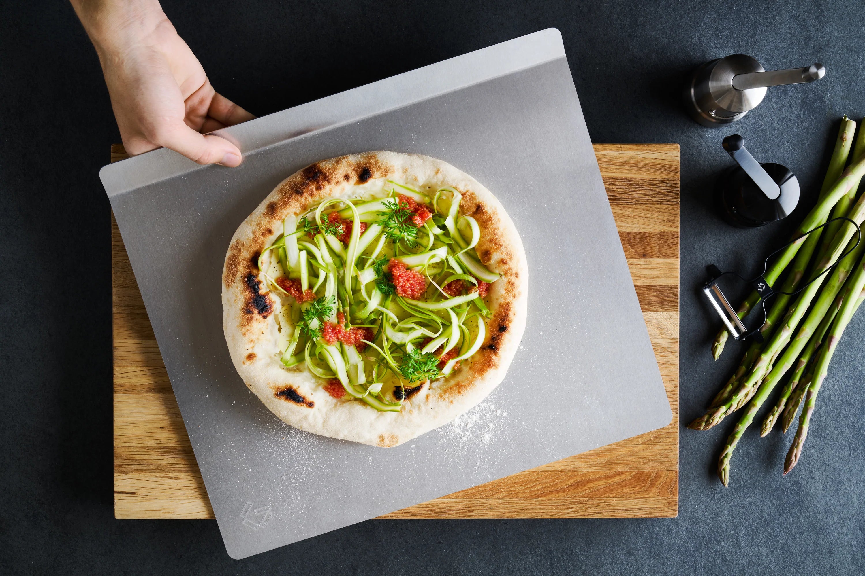 Potato pizza with vendace roe and green asparagus